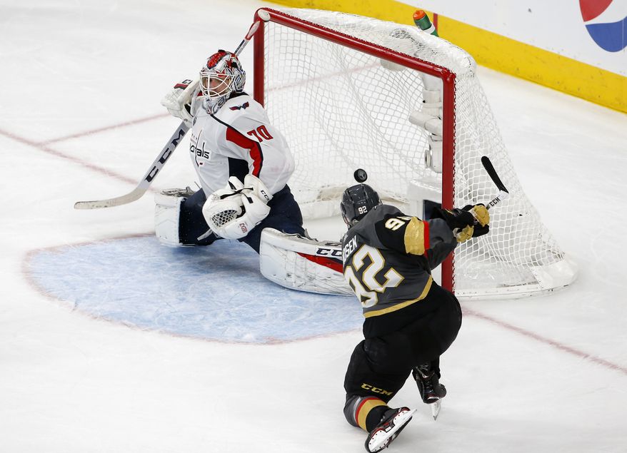 Washington Capitals goaltender Braden Holtby, left, is scored on by Vegas Golden Knights left wing Tomas Nosek, of the Czech Republic, during the third period in Game 1 of the NHL hockey Stanley Cup Finals Monday, May 28, 2018, in Las Vegas. (AP Photo/Ross D. Franklin)