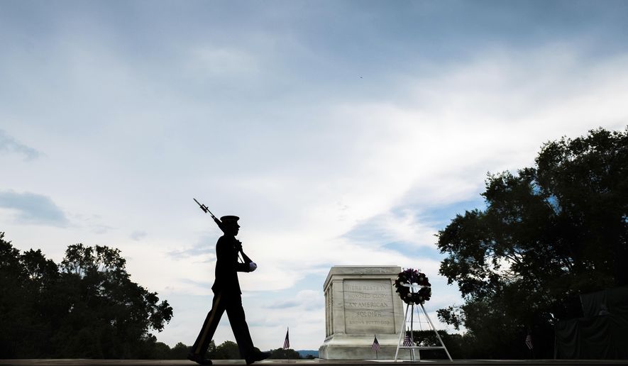 A member of the U.S. Army 3rd Infantry Regiment walks his post in front of The Tomb of the Unknown Soldier in Arlington National Cemetery during the Memorial Day weekend in Arlington, Va., Sunday, May 27, 2018. (AP Photo/J. David Ake)