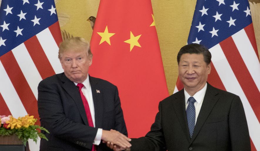 FILE - In this Nov. 9, 2017 file photo, President Donald Trump and Chinese President Xi Jinping shake hands during a joint statement to members of the media Great Hall of the People in Beijing, China. The U.S. is announcing that it will impose a 25 percent tariff on $50 billion worth of Chinese goods containing 