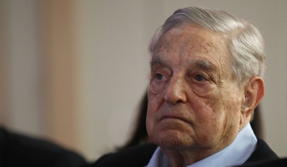 George Soros, founder and chairman of the Open Society Foundations, listens to the conference after his speech titled "How to save the European Union" as he attends the European Council On Foreign Relations Annual Council Meeting in Paris, Tuesday, May 29, 2018. (AP Photo/Francois Mori)