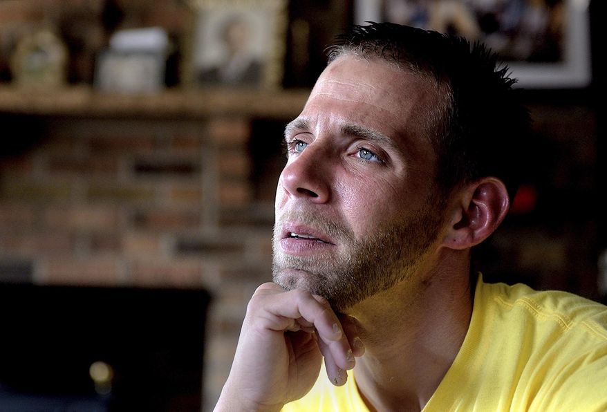 In a Friday, May 4, 2018 photo, Jason Wasylenko, 32, poses in his Falls Township, Pa., home. Wasylenko has spent a total of about 11 years behind bars since 2003, as he battled his heroin addiction. (Kim Weimer/Bucks County Courier Times via AP)