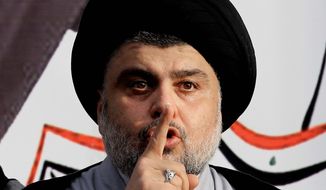 In this March 27, 2016, file photo, Shiite cleric Muqtada al-Sadr gives a speech to his followers before entering the highly fortified Green Zone, in Baghdad, Iraq. Al-Sadr, the influential maverick Shiite cleric whose political coalition beat out Iran&#39;s favored candidates to come in first in national elections, says he wants to form a government that puts Iraqis first. (AP Photo/Karim Kadim, File)