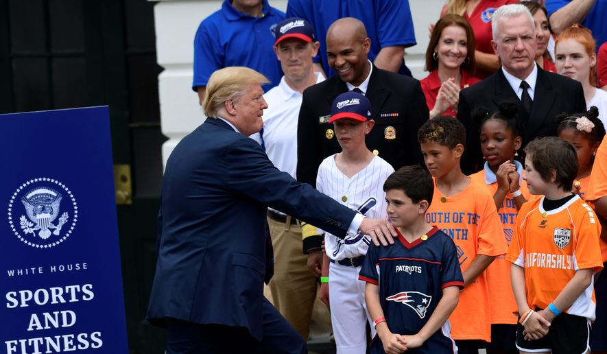 President Trump arrives to speak at the White House Sports and Fitness Day event on the South Lawn of the White House on Wednesday. The Trump administration seeks to reverse a trend in declining participation in team sports. (ASSOCIATED PRESS)