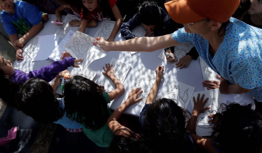 Children detained at a U.S. Customs and Border Protection processing facility color and draw, part of the many activities as well as meals and clothing they are provided at taxpayer expense. (Associated Press)