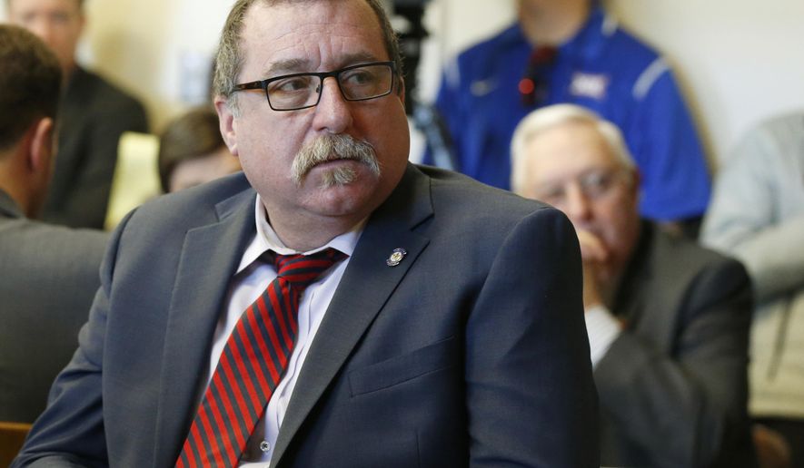 FILE - In this Feb. 8, 2018, file photo, Oklahoma state Rep. Mark McBride, listens during a committee hearing in Oklahoma City. The president of a Texas-based wind energy trade group has been subpoenaed to appear before an Oklahoma grand jury looking into McBride's claim that someone connected to the industry is responsible for putting a tracking device on his pickup. The Republican has worked on worked on legislation to tax wind-energy companies. (AP Photo/Sue Ogrocki, File)