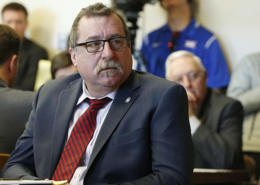 FILE - In this Feb. 8, 2018, file photo, Oklahoma state Rep. Mark McBride, listens during a committee hearing in Oklahoma City. The president of a Texas-based wind energy trade group has been subpoenaed to appear before an Oklahoma grand jury looking into McBride's claim that someone connected to the industry is responsible for putting a tracking device on his pickup. The Republican has worked on worked on legislation to tax wind-energy companies. (AP Photo/Sue Ogrocki, File)