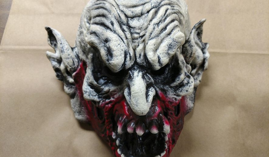 This May 27, 2018 photo made available by the Holly Hill Police Department, Fla., shows the clown mask that a suspect was wearing while committing a crime. The suspect was swinging a bat at an employee of a Little Caesars restaurant on Saturday night. The employee shot and killed the suspect. (Steve Alrich/Holly Hill Police Dept. via AP)