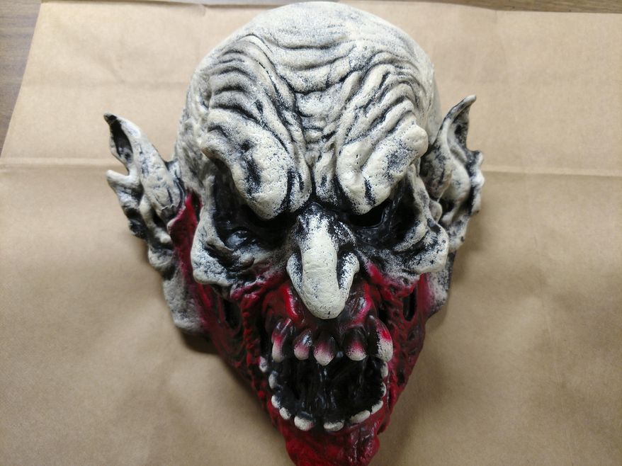 This May 27, 2018 photo made available by the Holly Hill Police Department, Fla., shows the clown mask that a suspect was wearing while committing a crime. The suspect was swinging a bat at an employee of a Little Caesars restaurant on Saturday night. The employee shot and killed the suspect. (Steve Alrich/Holly Hill Police Dept. via AP)