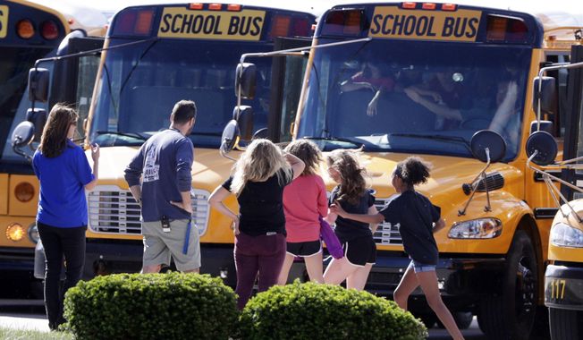 Students exits their buses as they return to class for the first time at Noblesville West Middle School in Noblesville, Ind., Wednesday, May 30, 2018.  Noblesville Schools&#x27; spokeswoman Marnie Cooke says it will operate on the same shortened schedule as the district&#x27;s final two days of classes Thursday and Friday. Cooke says the school will focus on counseling and &amp;quot;team building&amp;quot; over the final three days of the school year.  (AP Photo/Michael Conroy)
