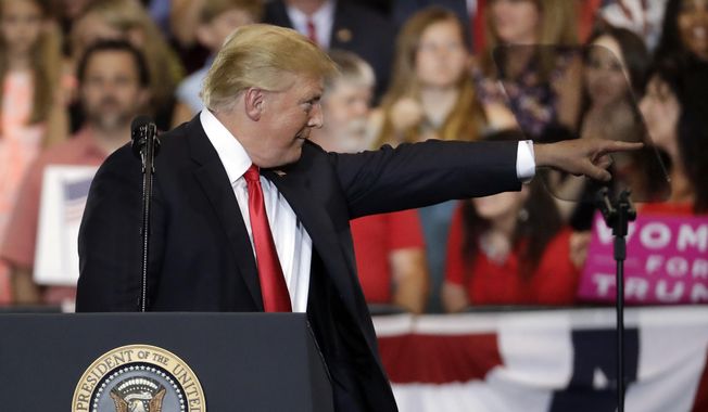 President Donald Trump points to an audience member as he speaks at a rally at the Nashville Municipal Auditorium Tuesday, May 29, 2018, in Nashville, Tenn. (AP Photo/Mark Humphrey)