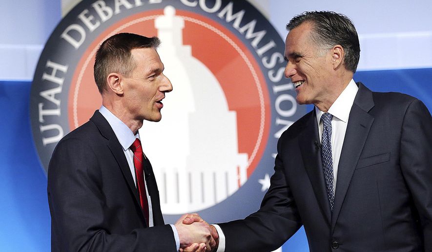 Utah Senate candidates, state Rep. Mike Kennedy, R-Alpine, left, and former Massachusetts Gov. Mitt Romney shake hands at the beginning of a Senate Republican primary debate, Tuesday, May 29, 2018, in Provo, Utah. (Scott G Winterton/The Deseret News via AP, Pool)