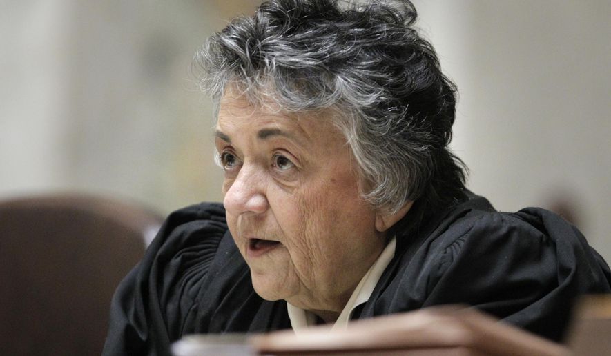 FILE- In this Nov. 11, 2013 file photo, Wisconsin Supreme Court chief justice Shirley Abrahamson questions state attorney general J.B. Van Hollen, during arguments in Madison Teachers Inc. vs. Scott Walker, in the Wisconsin Supreme Court at the state Capitol in Madison, Wis. Abrahamson, 84, the longest-serving Wisconsin Supreme Court justice in state history and the first woman to serve on the high court, said Wednesday, May 30, 2018, that she will not seek re-election next year, setting up a wide open race to replace her. (M.P. King /Wisconsin State Journal via AP, Pool, File)