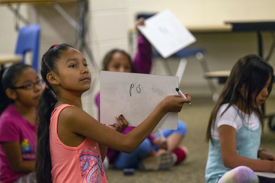 Students use erasable boards to write letters from the Lakota alphabet during a Lakota immersion class at General Beadle Elementary School in Rapid City, S.D., Thursday, May 17, 2018. (Ryan Hermens/Rapid City Journal via AP)