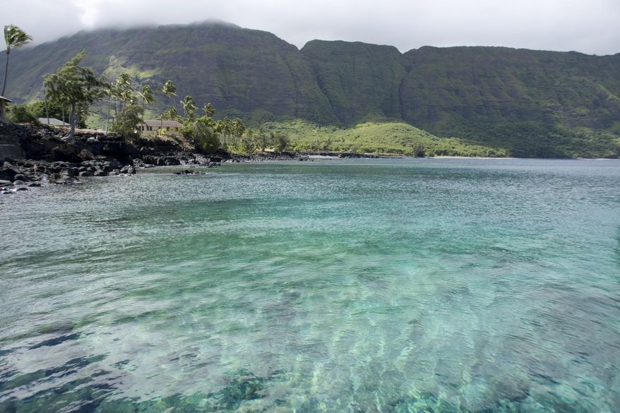 FILE - In this Aug. 12, 2008, file photo, the Molokai Island's sea cliffs rise in the background in Kalaupapa, Hawaii. Hawaii's Kilauea volcano has captivated people around the world by shooting lava high into the sky and sending rivers of molten rock pouring down hillsides into the ocean over the past month, but it's only one of many volcanoes in the islands. (AP Photo/Hugh Gentry, File)