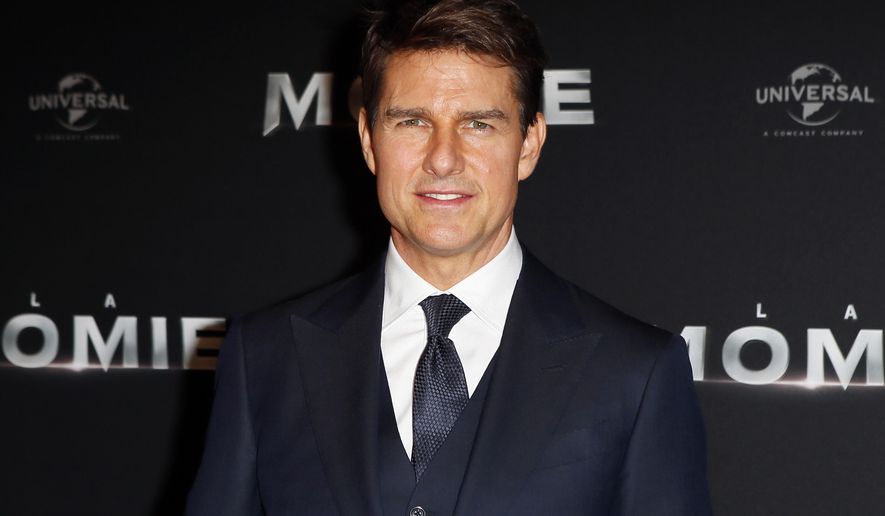 FILE - In this Tuesday, May 30, 2017, file photo, Tom Cruise poses during a photocall for the French premiere of "The Mummy" in Paris, France. Cruise is back on the flight line for a sequel to the 1986 film “Top Gun.” The actor on Thursday, May 31, 2018, tweeted a photo of himself as Navy pilot Pete “Maverick” Mitchell in a flight suit, looking at a fighter jet. The photo includes the phrase “feel the need” In the original movie, Cruise’s character talks about how he feels the need for speed. (AP Photo/Francois Mori, File)