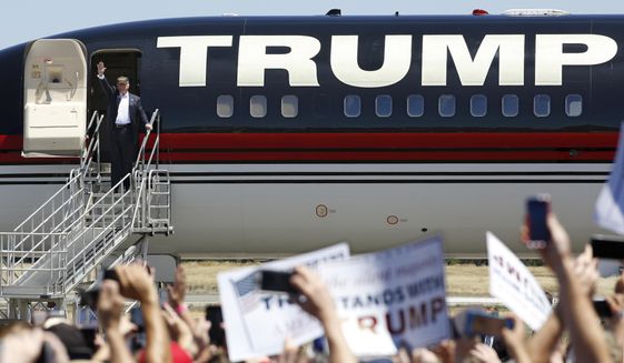 In this June 3, 2016, file photo, then-Republican presidential candidate Donald Trump waves to the crowd as he disembarks from his plane for a campaign rally at the Redding Municipal Airport in Redding, Calif. (AP Photo/Rich Pedroncelli, File)