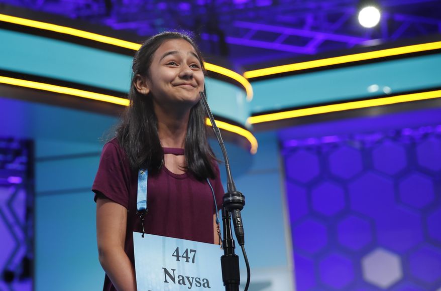 Naysa Modi, 12, from Frisco, Texas, reacts to spelling a word correctly during the final round of the Scripps National Spelling Bee in Oxon Hill, Md., Thursday, May 31, 2018. (AP Photo/Carolyn Kaster)