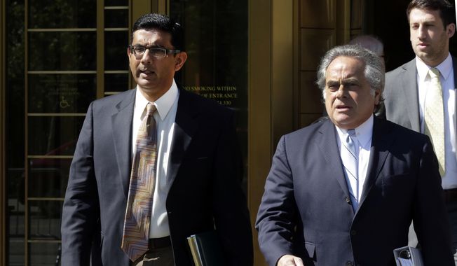 In this May 20, 2014 file photo, conservative scholar and filmmaker Dinesh D&#x27;Souza, left, accompanied by his lawyer Benjamin Brafman leaves federal court, in New York. (AP Photo/Richard Drew) ** FILE **