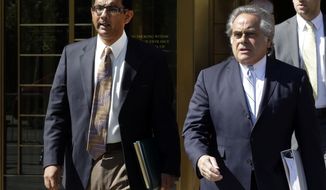 FILE - In this May 20, 2014 file photo, conservative scholar and filmmaker Dinesh D&#39;Souza, left, accompanied by his lawyer Benjamin Brafman leaves federal court, in New York. President Donald Trump says he will pardon conservative commentator Dinesh D&#39;Souza who pleaded guilty to campaign finance fraud. Trump tweeted Thursday: “Will be giving a Full Pardon to Dinesh D’Souza today. He was treated very unfairly by our government!” D’Souza was sentenced in 2014 to five years’ probation after he pleaded guilty to violating federal election law.  (AP Photo/Richard Drew)