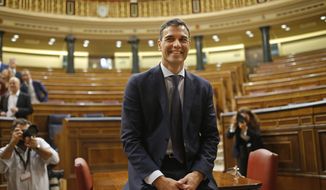 Socialist leader Pedro Sanchez poses in the parliament after a motion of no confidence vote at the Spanish parliament in Madrid, Friday, June 1, 2018. Opposition Socialist leader Pedro Sanchez has won the vote to replace Mariano Rajoy as prime minister, in the first ouster of a serving Spanish leader by parliament in four decades of democracy. (AP Photo/Francisco Seco)