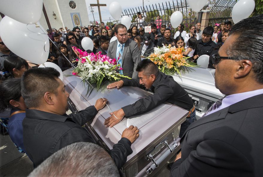 RETRANSMISSION TO CORRECT SURNAME TO PROFECTO - In this April 2, 2018 photo the son of Marcelina Garica Profecto cries on his mother's casket before the start of services in Delano, Calif. Profecto and her husband Santos Hilario Garcia, died in a car crash on March 13th while trying to evade ICE agents. They leave behind 6 children. The U.S. has deported a Mexican man who was being sought in California earlier this year when immigration agents mistakenly followed a related couple who sped away in their car and crashed, killing both and leaving six orphaned children. (Felix Adamo/The Bakersfield Californian via AP)