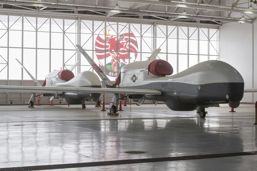 This undated photo released by Northrop Grumman Corporation in 2018 shows the first two operational MQ-4C Triton unmanned surveillance and patrol aircrafts that Northrop Grumman delivered to the U.S. Navy in Naval Base Ventura County Point Mugu, Calif. Builder Northrop Grumman says the single-engine jet can stay aloft for more than 24 hours. (Bob Brown/Northrop Grumman Corporation via AP)