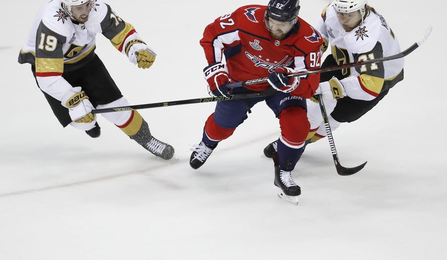 Vegas Golden Knights forwards Reilly Smith, left and William Karlsson, right, of Sweden, chase the puck with Washington Capitals forward Evgeny Kuznetsov (92), of Russia, during the second period in Game 3 of the NHL hockey Stanley Cup Final, Saturday, June 2, 2018, in Washington. (AP Photo/Pablo Martinez Monsivais) ** FILE **