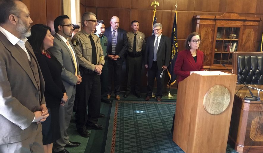 FILE - In this Feb. 2, 2017 file photo Oregon Gov. Kate Brown speaks during a news conference in the Capitol ceremonial office in Salem, Ore. Brown is asking Oregon's attorney general to bring legal action against the federal government over President Donald Trump's executive order on immigration. A conservative group is taking aim at the nation's oldest statewide sanctuary law, with a drive to repeal a 31-year-old Oregon mandate limiting police coordination on immigration arrests. (AP Photo/Andrew Selsky, File)