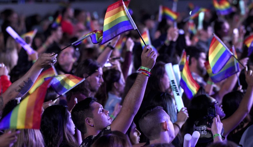 Fans waive rainbow flags in honor of LGBT Pride month at Wango Tango at Banc of California Stadium on Saturday, June 2, 2018, in Los Angeles. (Photo by Chris Pizzello/Invision/AP)