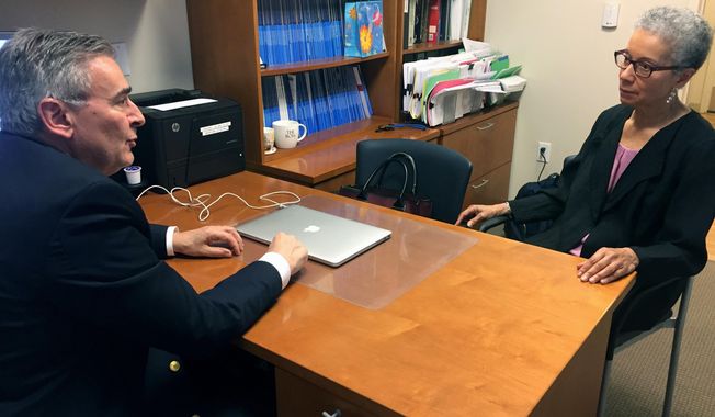 In this Thursday, May 24, 2018 photo, Adine Usher, 78, meets with breast cancer study leader Dr. Joseph Sparano at the Montefiore and Albert Einstein College of Medicine in the Bronx borough of New York. Usher was one of about 10,000 participants in the study which shows women at low or intermediate risk for breast cancer recurrence may safely skip chemotherapy without hurting their chances of survival. (AP Photo/Kathy Young)
