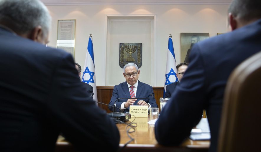 Israeli Prime Minister Benjamin Netanyahu, center, attends the weekly cabinet meeting at the Prime Minister&#x27;s office in Jerusalem Sunday, June 3, 2018 (AP Photo/Sebastian Scheiner, Pool)