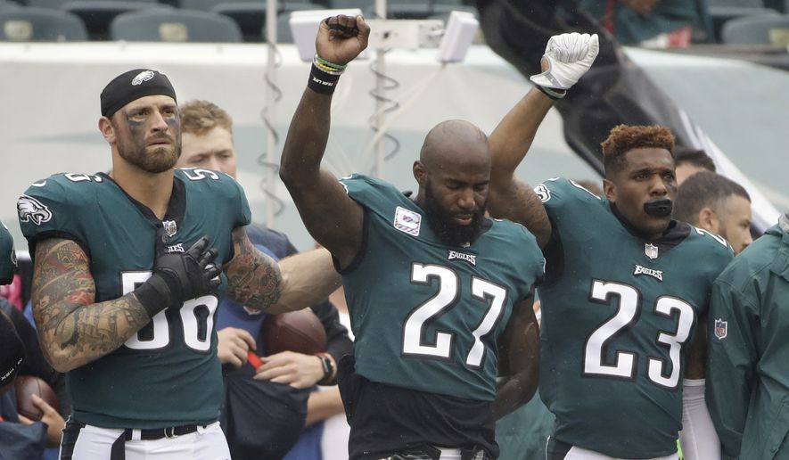 Philadelphia Eagles' Chris Long (56), Malcolm Jenkins (27) and Rodney McLeod (23) gesture during the National Anthem before an NFL football game against the Arizona Cardinals, Sunday, Oct. 8, 2017, in Philadelphia. (AP Photo/Matt Rourke)