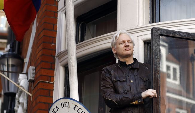 In this May 19, 2017, file photo, WikiLeaks founder Julian Assange greets supporters from a balcony of the Ecuadorian Embassy in London. (AP Photo/Frank Augstein, File)