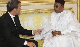 Niger&#39;s President Mahamadou Issoufou, right, meets with French President Emmanuel Macron at the presidential Elysee Palace in Paris, Monday, June 4, 2018. Macron called on international donors to quickly making financing available for the Sahel regional counterterror force. (Jacques Demarthon/Pool Photo via AP)