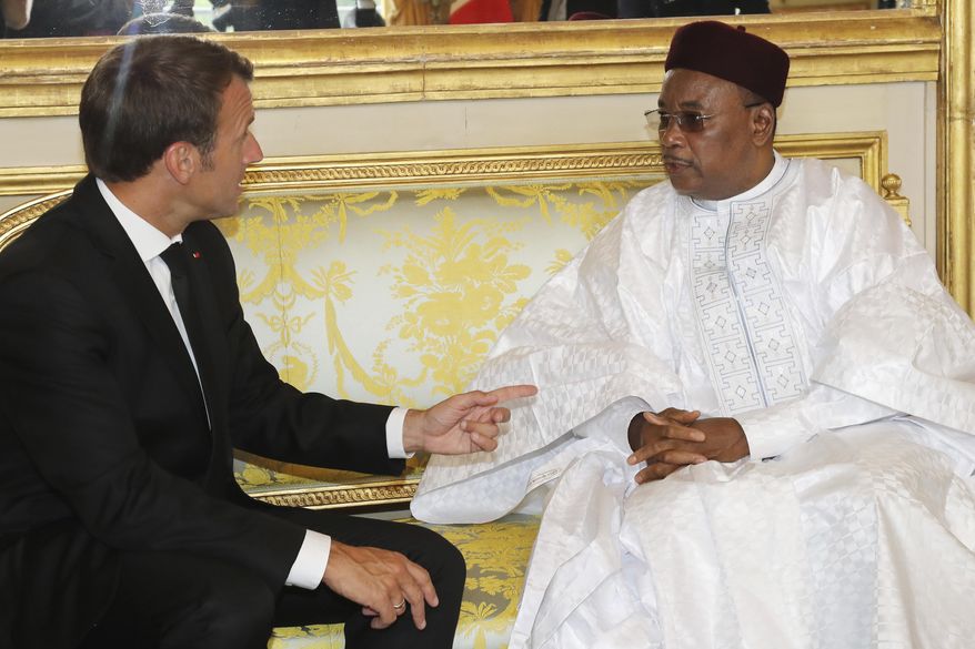 Niger's President Mahamadou Issoufou, right, meets with French President Emmanuel Macron at the presidential Elysee Palace in Paris, Monday, June 4, 2018. Macron called on international donors to quickly making financing available for the Sahel regional counterterror force. (Jacques Demarthon/Pool Photo via AP)