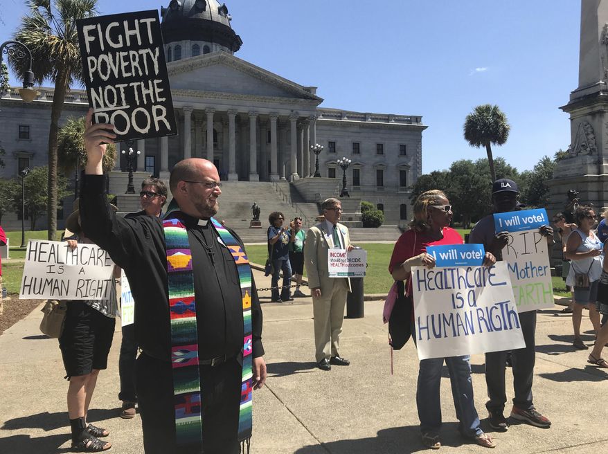 Protestors with the Poor People's Campaign are seen outside South Carolina Statehouse, Monday, June 4, 2018. The protestors called for a "moral revival" of the health care system and an immediate expansion on Medicaid. (AP Photo/Christina Myers)