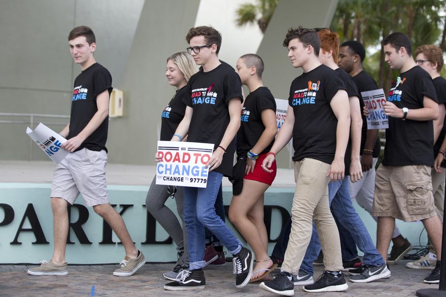 A group of Marjory Stoneman Douglas High School students arrive for a news conference, Monday, June 4, 2018, in Parkland, Fla. A day after graduating from high school, the group of Florida school shooting survivors has announced a multistate bus tour to "get young people educated, registered and motivated to vote." (AP Photo/Wilfredo Lee)