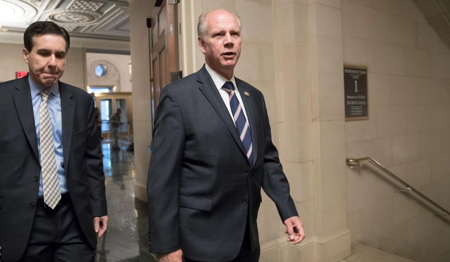 FILE — In this Nov. 2, 2017, file photo, Rep. Dan Donovan, R-N.Y., right, who represents Staten Island and South Brooklyn, arrives for a briefing on the GOP&#39;s far-reaching tax overhaul on Capitol Hill in Washington. Donovan faces former Republican Congressman Michael Grimm in a primary election later this month. President Donald Trump shined a spotlight on the Republican face-off on Staten Island by endorsing Donovan. (AP Photo/J. Scott Applewhite, File)