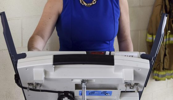 Republican State Sen. Sally Doty, a candidate for the Third Congressional District seat, left, votes in the party primary, at a Brookhaven, Miss., fire station, Tuesday, June 5, 2018. (Adam Northam/The Daily Leader via AP)