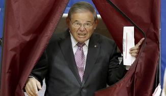 U.S. Sen. Bob Menendez exits a polling booth after casting his vote in the New Jersey primary election, Tuesday, June 5, 2018, at the Harrison Community Center in Harrison, N.J. (AP Photo/Julio Cortez)