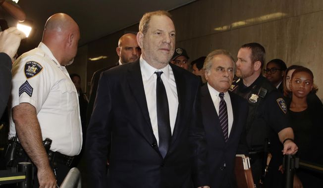 Harvey Weinstein, second left, accompanied by his attorney Benjamin Brafman, third left, arrives for his appearance in Supreme Court, in New York, Tuesday, June 5, 2018. Weinstein pleaded not guilty Tuesday to rape and criminal sex act charges in New York. The hearing in Manhattan comes after a grand jury indicted the former movie mogul last week on charges involving two women. (AP Photo/Richard Drew)