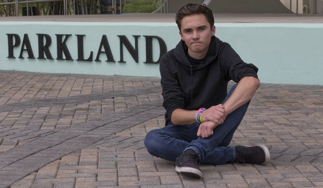 David Hogg, a senior at Marjory Stoneman Douglas High School, poses for a photo at Pine Trails Park, Tuesday, May 29, 2018, in Parkland, Fla. Hogg, one of the leaders of the March For Our Lives movement, is spearheading the national effort to register young voters along with the New York-based organization HeadCount. They say students at more than 1,000 schools in 46 states are participating, with most starting their drives Tuesday. (AP Photo/Wilfredo Lee)