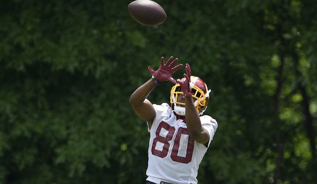 Washington Redskins wide receiver Jamison Crowder leaps to make a catch during an NFL football team practice, Wednesday, June 6, 2018, in Ashburn, Va. (AP Photo/Nick Wass) **FILE**
