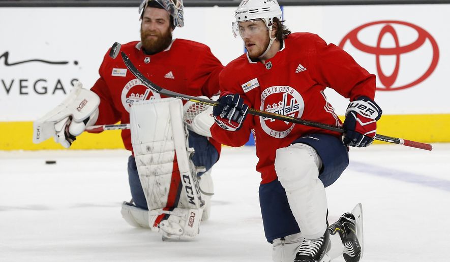 Washington Capitals&#39; T.J. Oshie (77) flips the puck in the air as goalie Braden Holtby, left, looks on during an NHL hockey practice Wednesday, June 6, 2018, in Las Vegas. The Capitals lead the Vegas Golden Knights 3-1 in the best-of-seven Stanley Cup Finals series. (AP Photo/Ross D. Franklin)