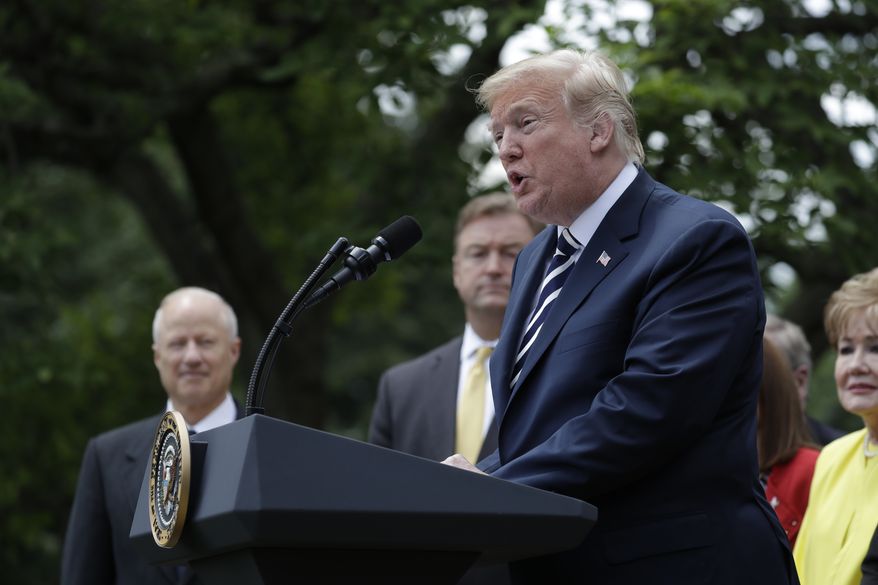 President Donald Trump participates in a bill signing ceremony for the "VA Mission Act" in the Rose Garden of the White House, Wednesday, June 6, 2018, in Washington. (AP Photo/Evan Vucci)