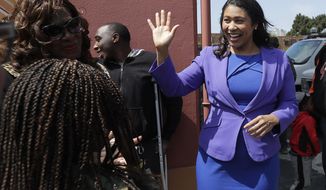Board of Supervisors President London Breed, right, greets supporters after speaking to reporters in San Francisco, Wednesday, June 6, 2018. Former state Sen. Mark Leno pulled ahead in San Francisco&#39;s race for mayor by the slimmest of margins early Wednesday under the city&#39;s unusual voting system, although Breed maintained her lead in first-place votes. (AP Photo/Jeff Chiu)
