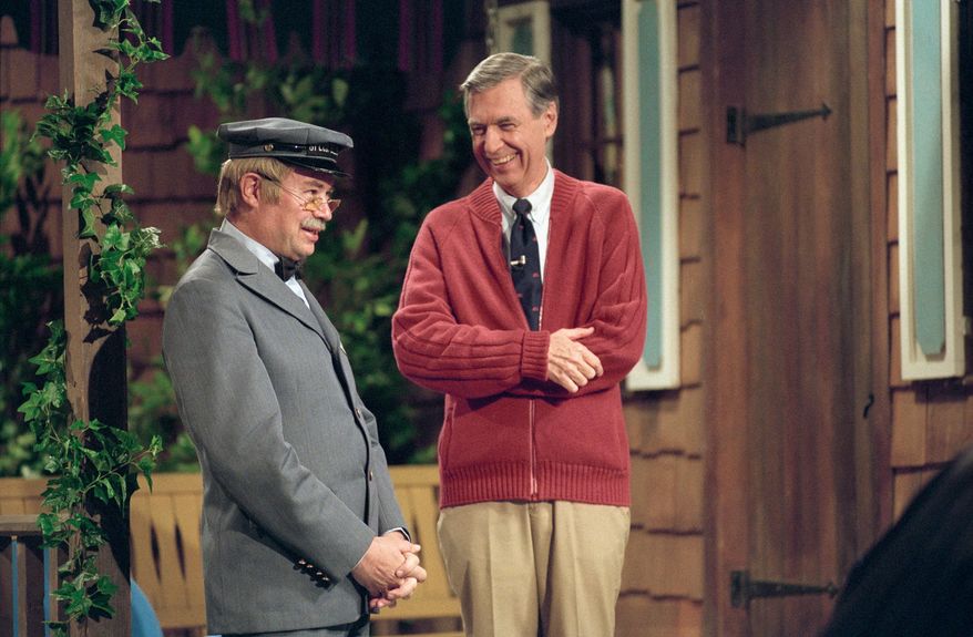 This image released by Focus Features shows David Newell, as Mr. McFeely, left, and Fred Rogers on the set of "Mister Rogers' Neighborhood," from the film, "Won't You Be My Neighbor." (Lynn Johnson/Focus Features via AP)