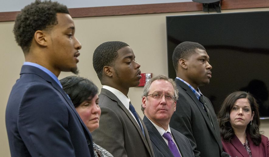 Former Michigan State University football players, from left, Demetric Vance, with defense attorney Mary Chartier, Donnie Corley, with defense attorney John Shea, and Josh King, with defense attorney Shannon Smith, appear for their sentencing at Ingham County 30th Circuit Court in Lansing, Mich., on Wednesday, June 6, 2018. King, Corley and Vance all pleaded guilty to a felony charge of seduction in a sexual assault case. King also pleaded to a felony charge of surveilling an unclothed person. (Cory Morse /The Grand Rapids Press via AP)