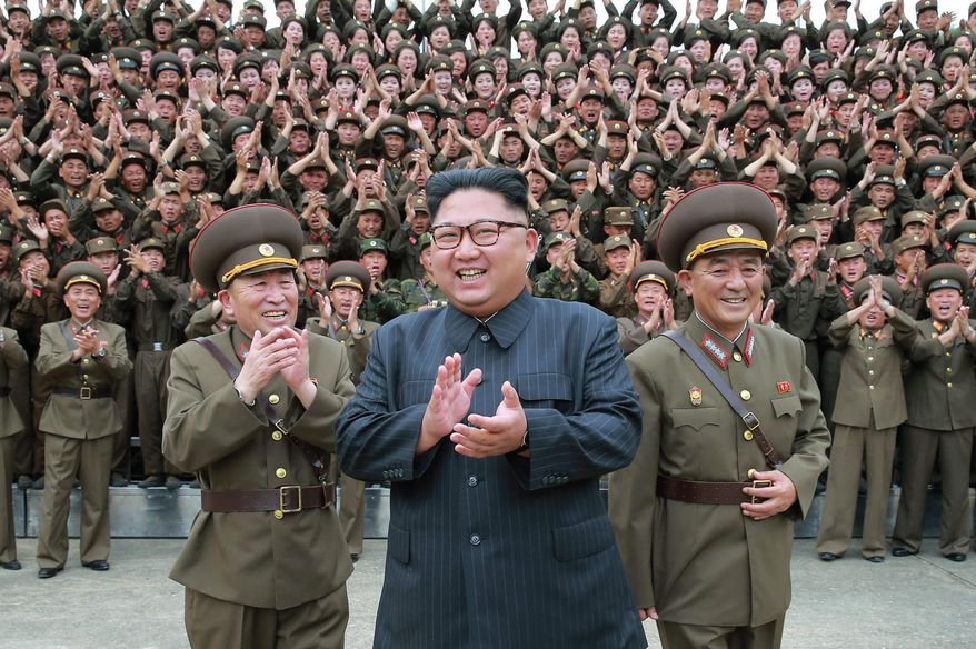 FILE - In this Aug. 14, 2017, file photo distributed by the North Korean government, North Korean leader Kim Jong Un acknowledges a welcome from the military officers during his visit to Korean People's Army's Strategic Forces in North Korea. Kim’s diplomatic charm offensive could be a godsend for his generals. There is virtually no aspect of the North Korean economy that doesn’t have the military’s fingerprints all over it. If Kim’s strategy of busting support for sanctions by negotiating with U.S. President Donald Trump and others pays off, his million-man military could be one of the biggest winners. Independent journalists were not given access to cover the event depicted in this image. (Korean Central News Agency/Korea News Service via AP, File)