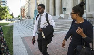 In this Tuesday, June 5, 2018, photo, former NFL running back Reggie Bush leaves the Civil Courts building with his legal team in St. Louis. Bush says dangerous conditions at a St. Louis stadium led to a season-ending injury in a case that could leave the city on the hook for damages, even though the Rams are long gone. Bush was playing for the San Francisco 49ers in November 2015 when he slipped and fell in a game after being pushed out of bounds at the former Edward Jones Dome. (Ryan Michalesko/St. Louis Post-Dispatch via AP)